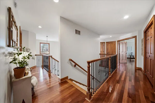 a kitchen with stainless steel appliances granite countertop a table chairs sink and white cabinets