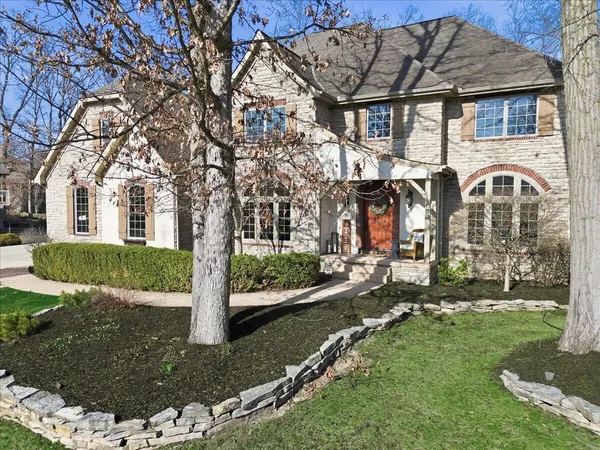 a view of a white house with a yard and garage