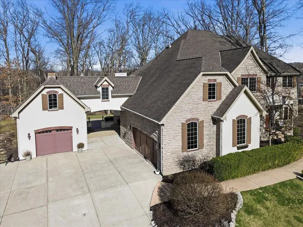 an aerial view of residential houses with outdoor space and parking
