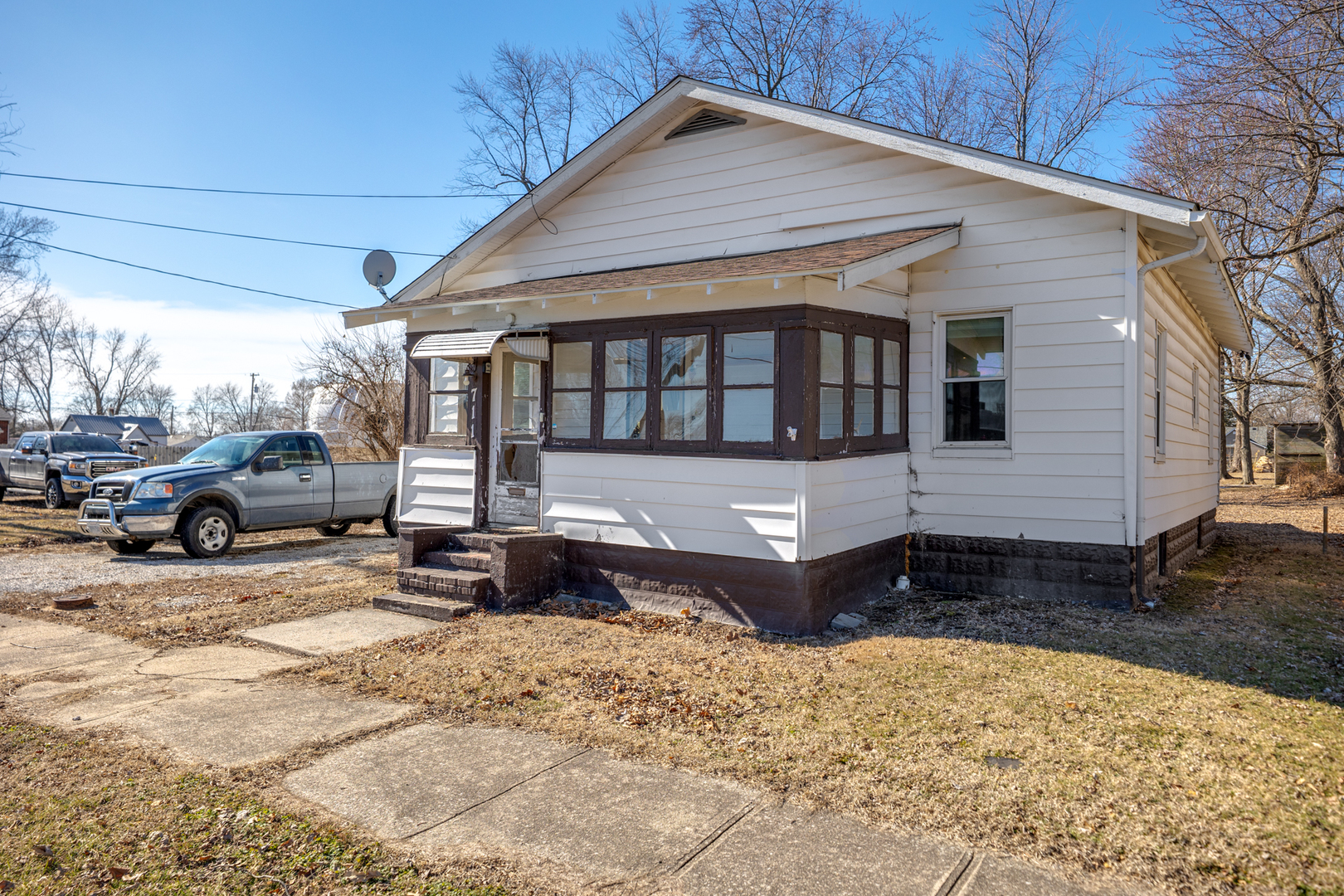 a front view of a house with a yard covered in snow
