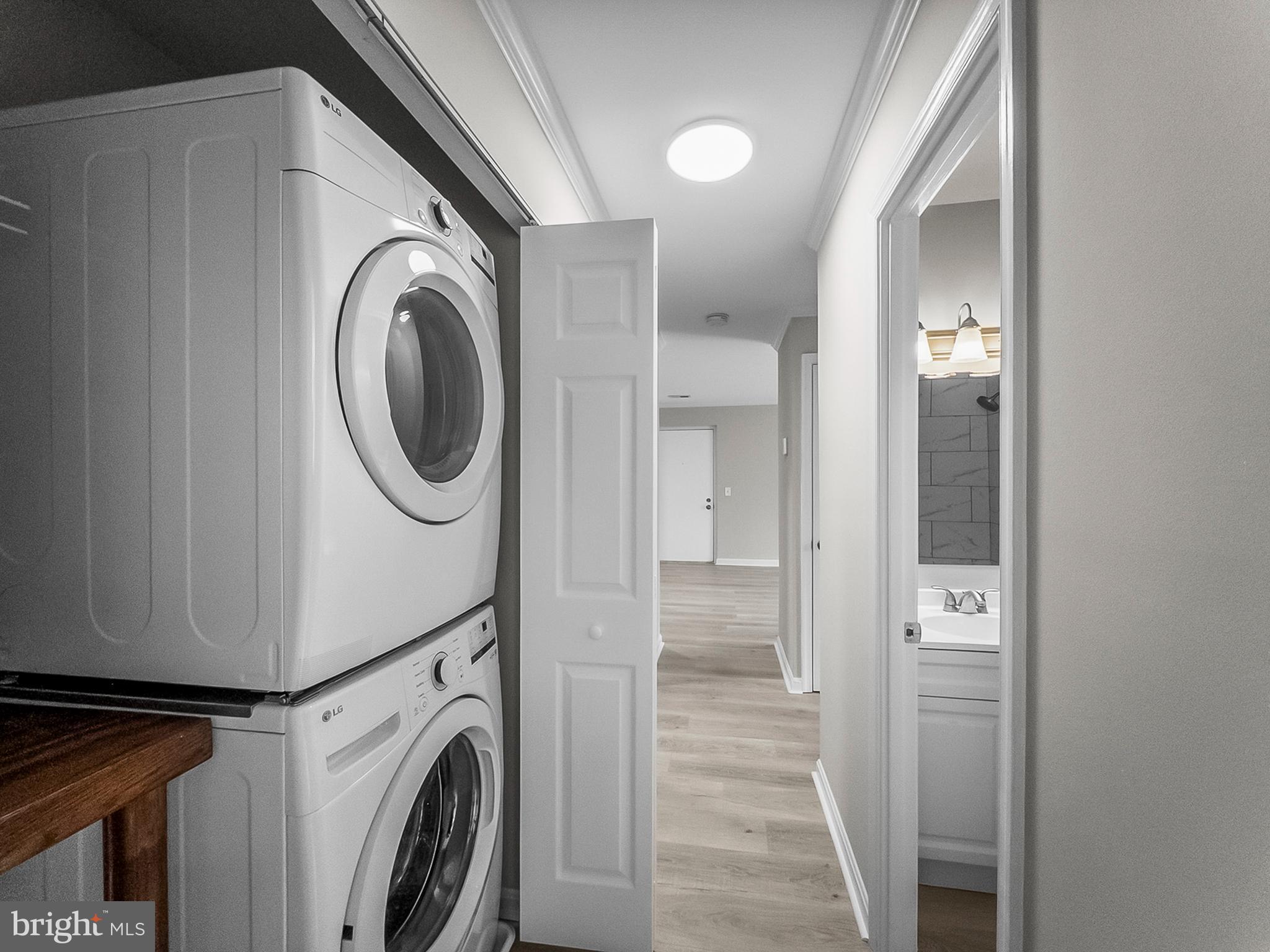 18304 Streamside Drive, Unit 301 Gaithersburg, MD 20879 - Photo 25 of 31 a view of a hallway with washer and dryer