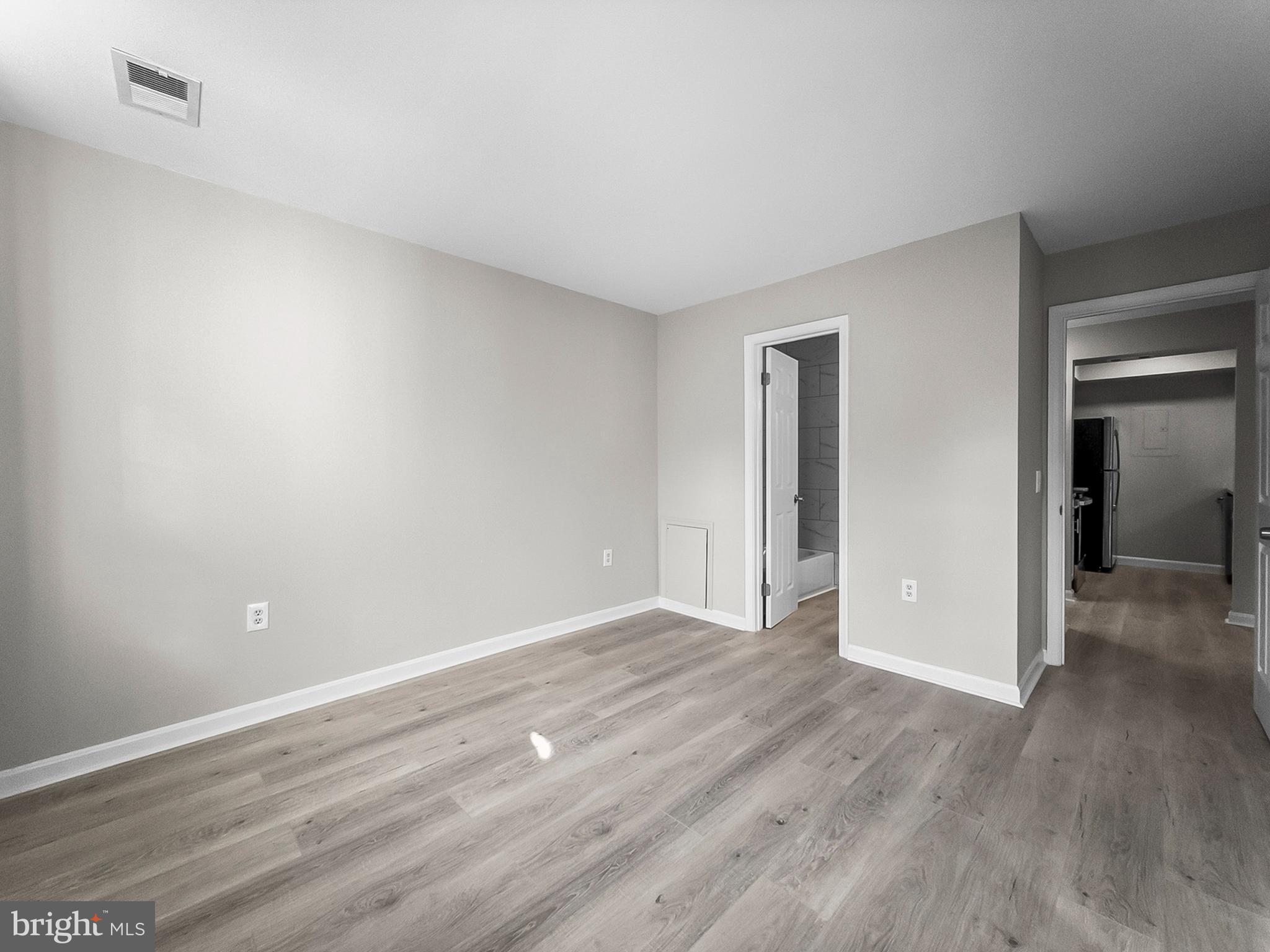 18304 Streamside Drive, Unit 301 Gaithersburg, MD 20879 - Photo 26 of 31 a view of an empty room with wooden floor & closet