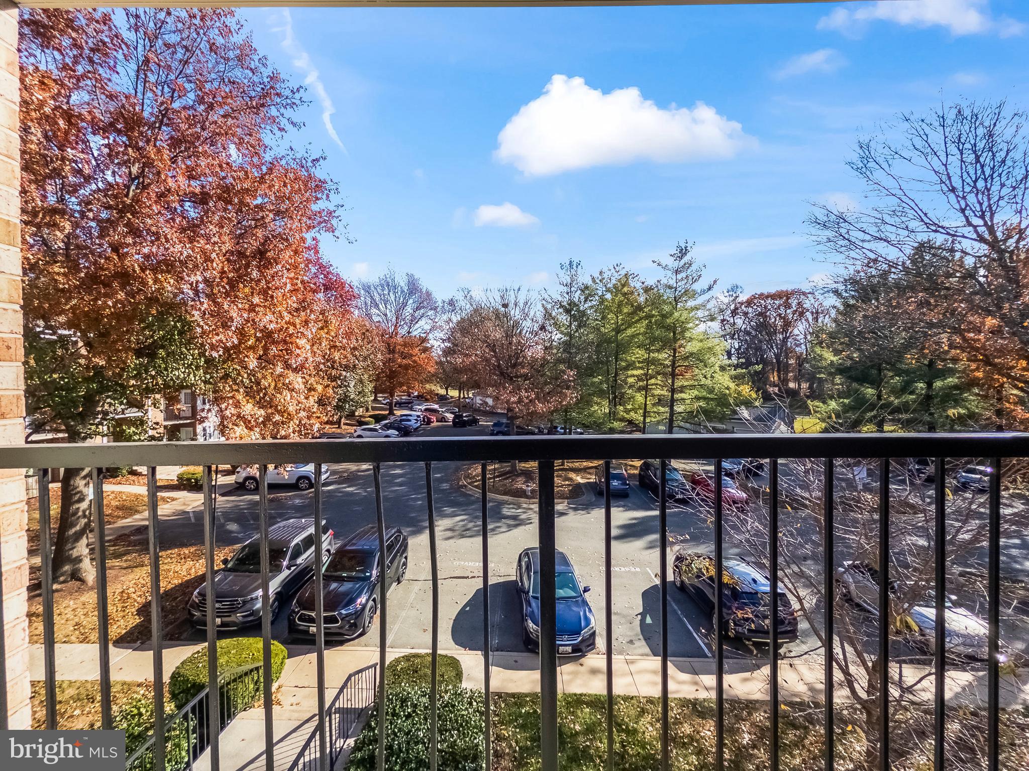 18304 Streamside Drive, Unit 301 Gaithersburg, MD 20879 - Photo 29 of 31 a view of a balcony with chairs and wooden floor