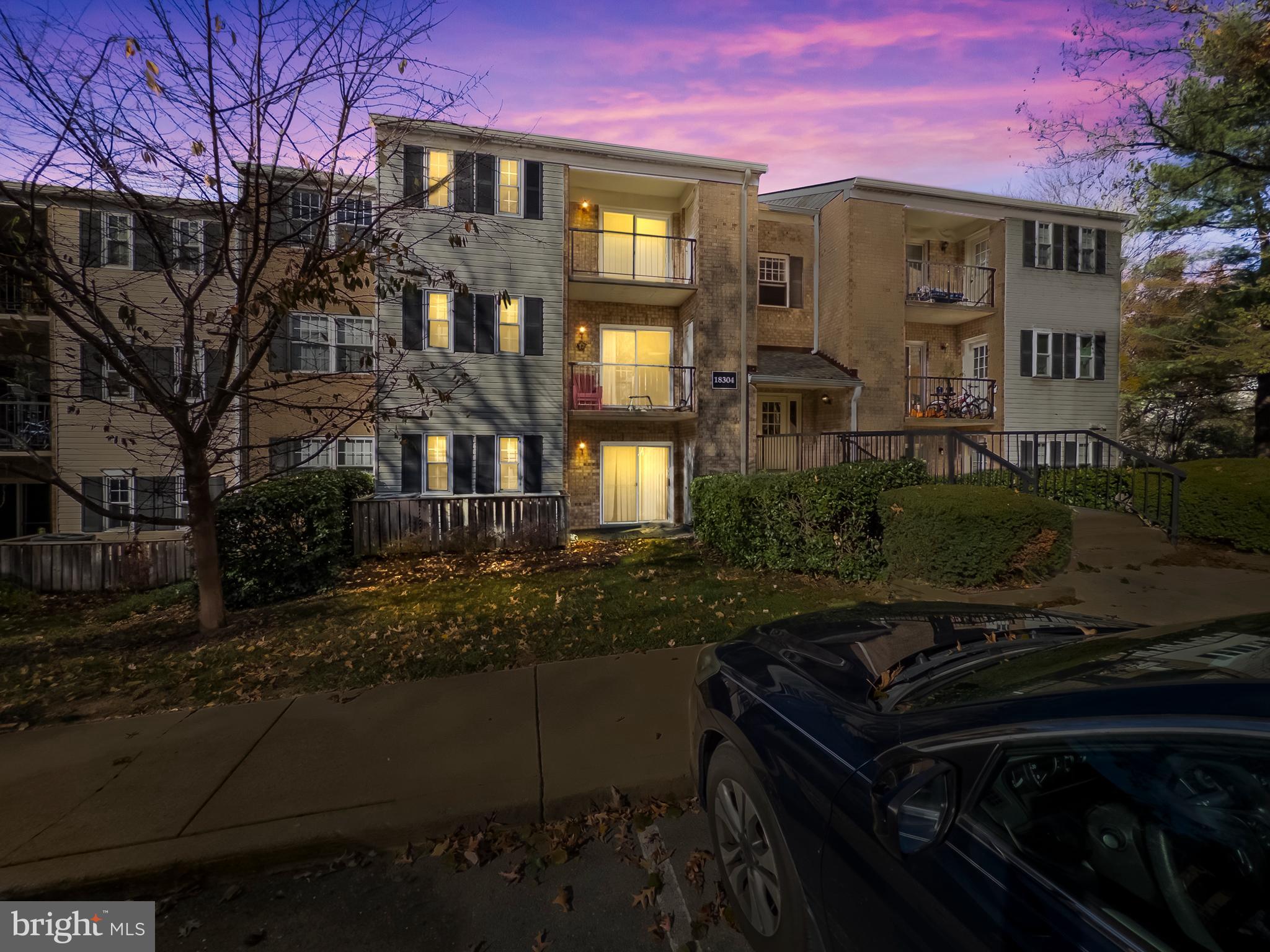 18304 Streamside Drive, Unit 301 Gaithersburg, MD 20879 - Photo 30 of 31 a front view of a house with a yard