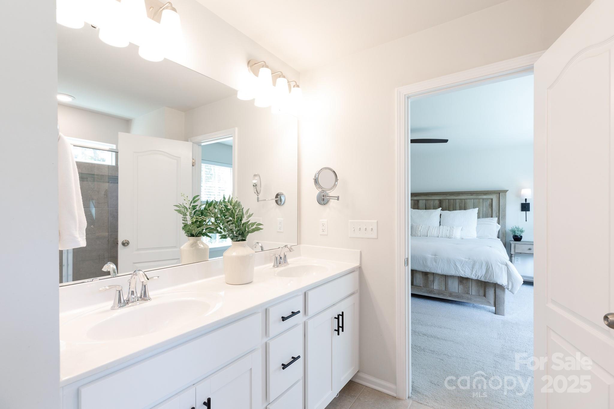 1207 Loggerhead Drive Lancaster, SC 29720 - Photo 12 of 25 a en suite bathroom with a double sink and mirror