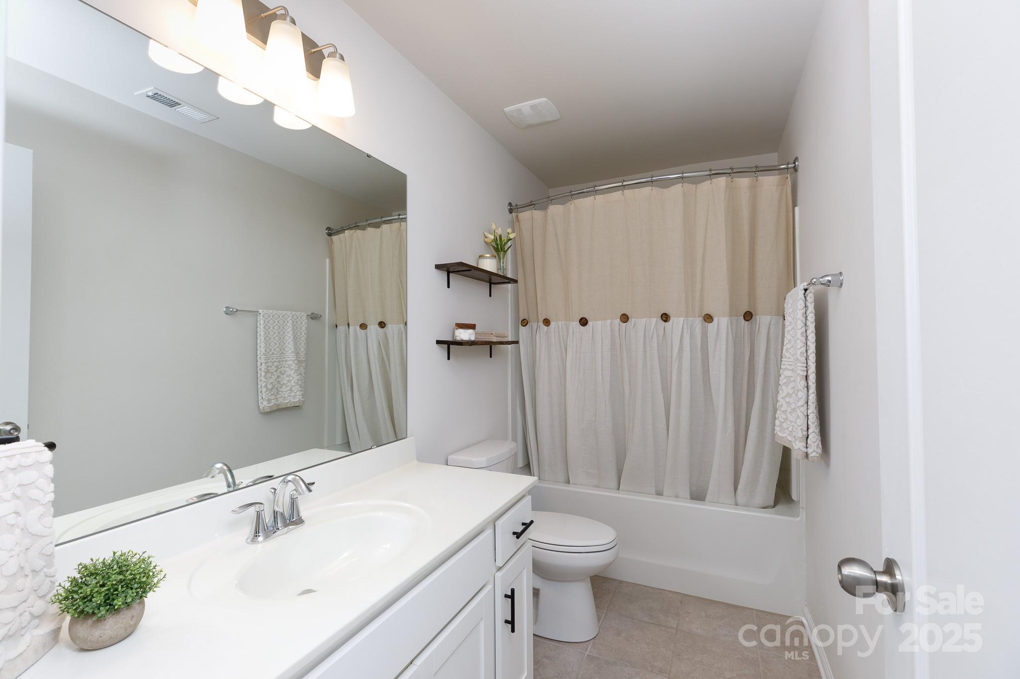 1207 Loggerhead Drive Lancaster, SC 29720 - Photo 16 of 25 a bathroom with a sink vanity mirror and toilet