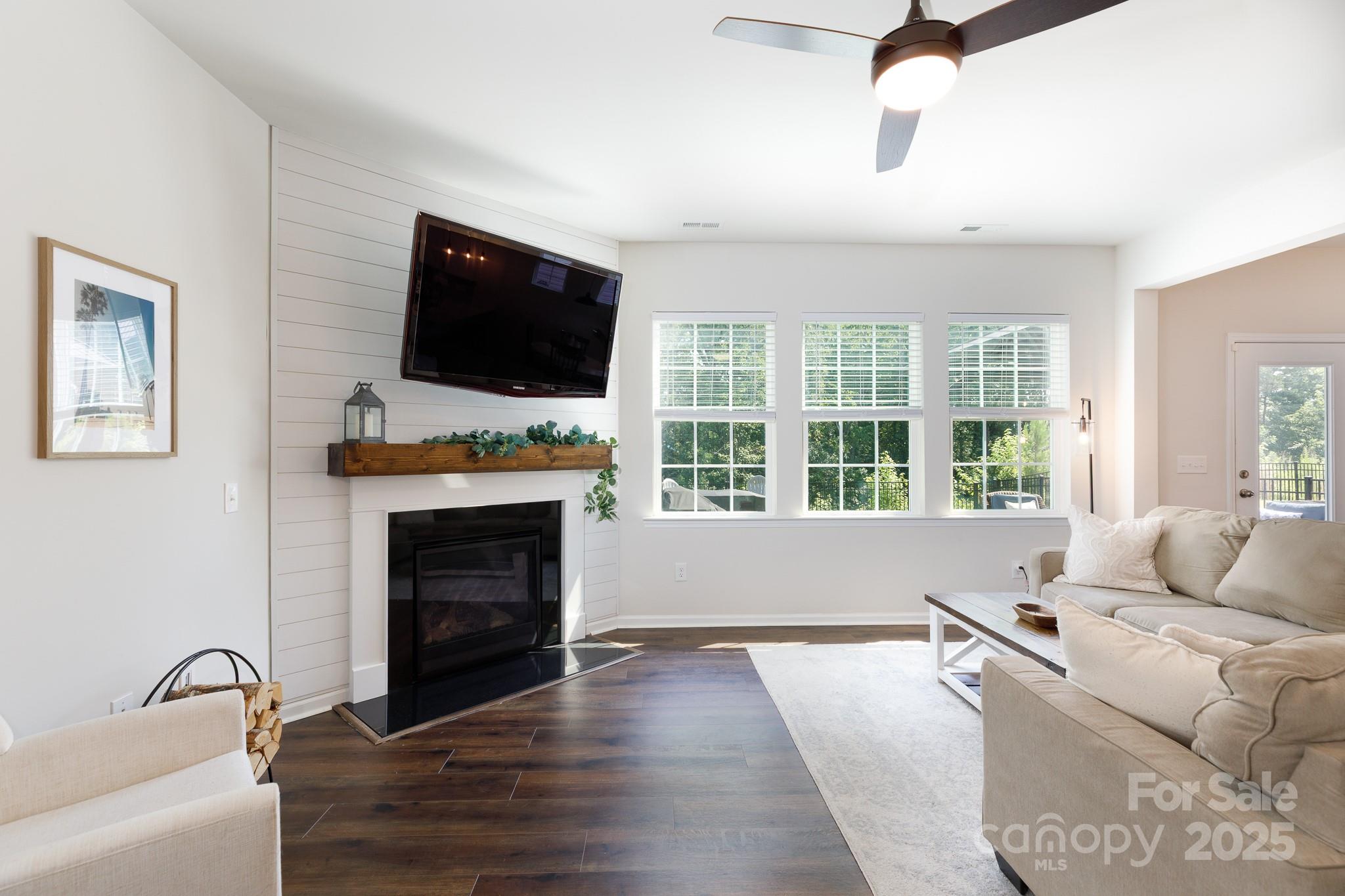 1207 Loggerhead Drive Lancaster, SC 29720 - Photo 5 of 25 a living room with furniture a flat screen tv and a fireplace