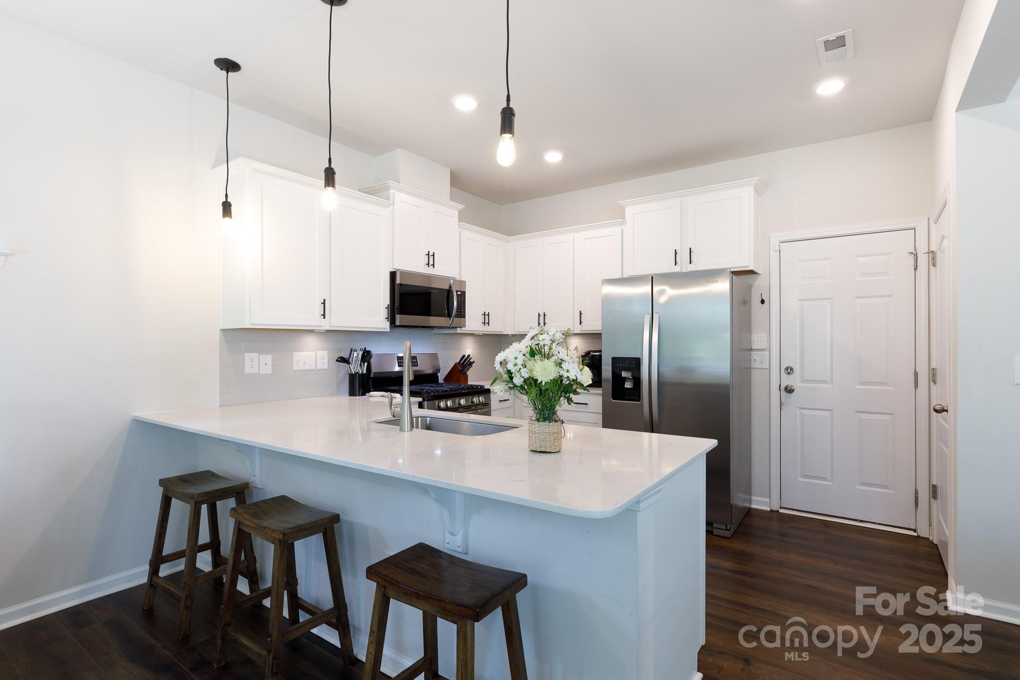 1207 Loggerhead Drive Lancaster, SC 29720 - Photo 8 of 25 a kitchen with kitchen island a counter space a sink and appliances