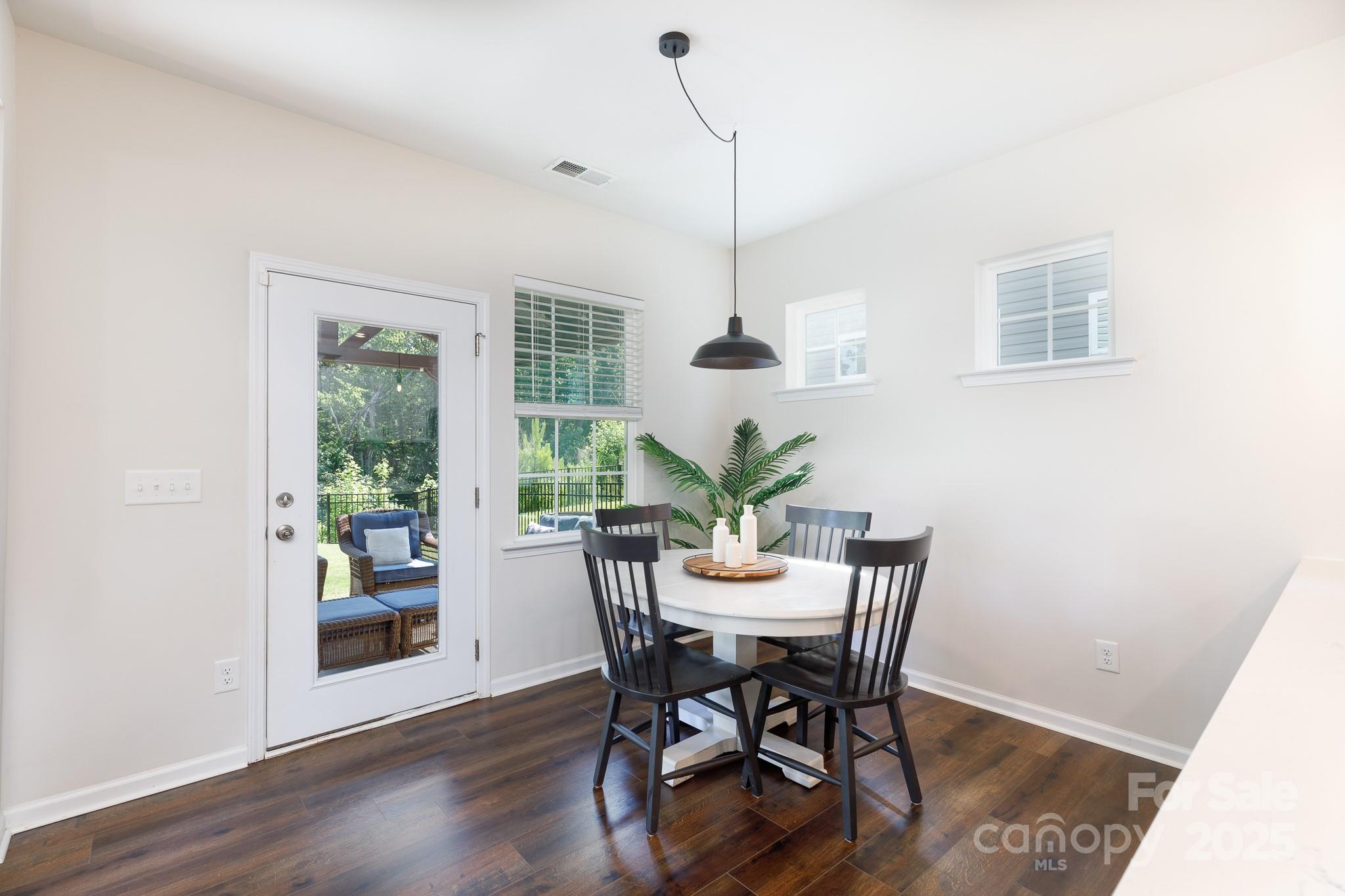 1207 Loggerhead Drive Lancaster, SC 29720 - Photo 9 of 25 a view of a dining room with furniture window and wooden floor