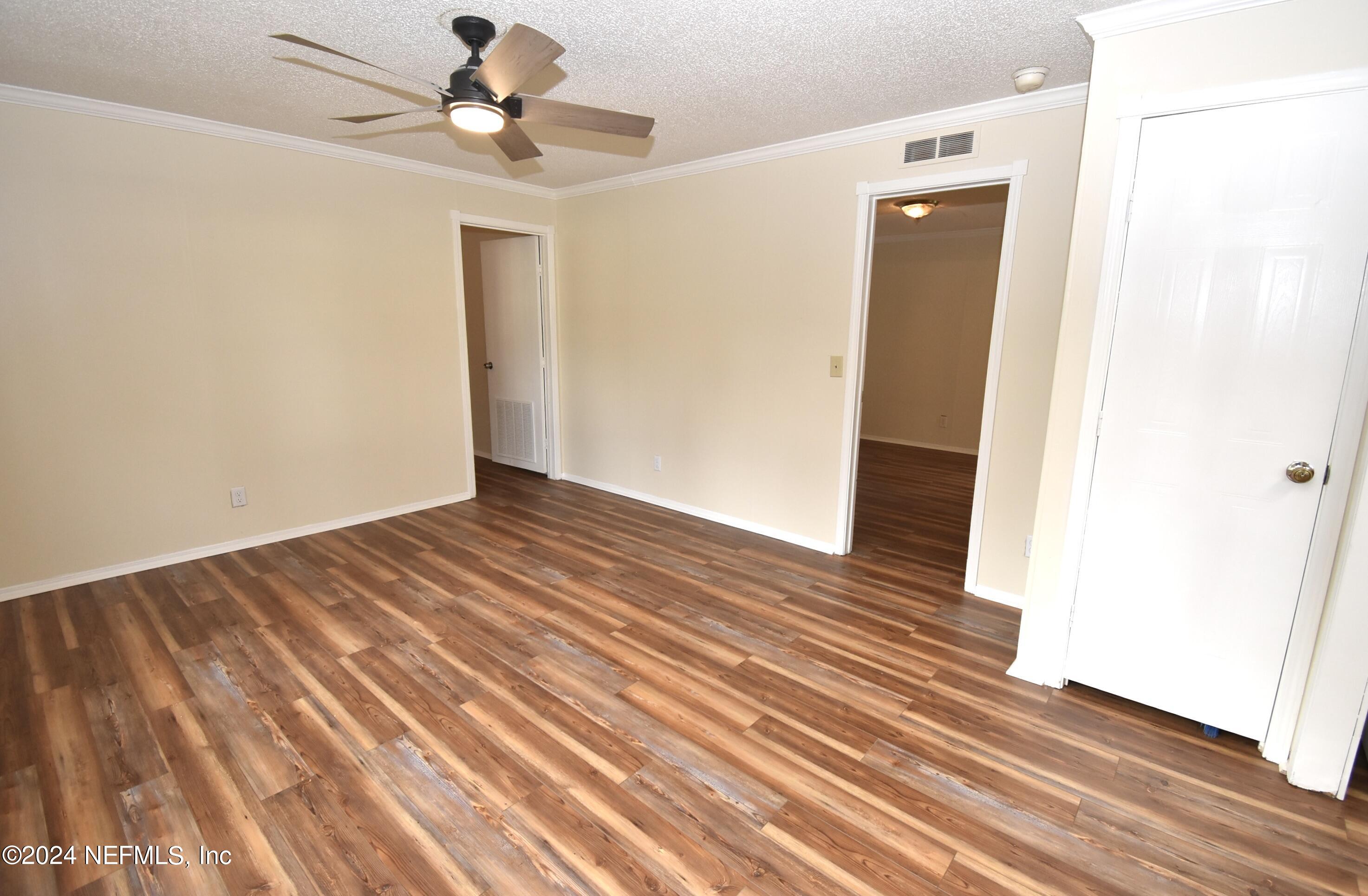 989 Shell Street Welaka, FL 32193 - Photo 15 of 34 a view of empty room with wooden floor