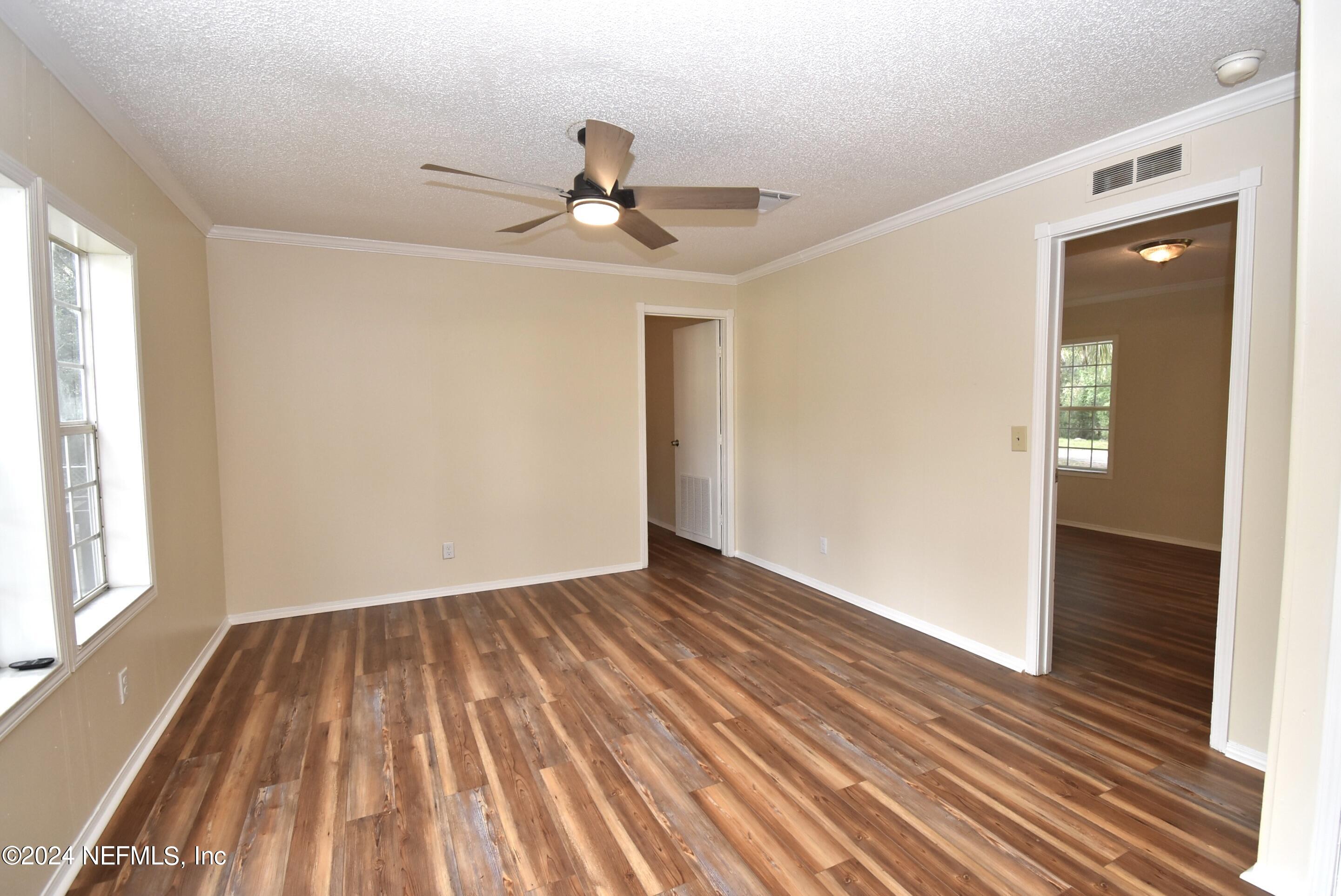 989 Shell Street Welaka, FL 32193 - Photo 23 of 34 a view of empty room with wooden floor and fan