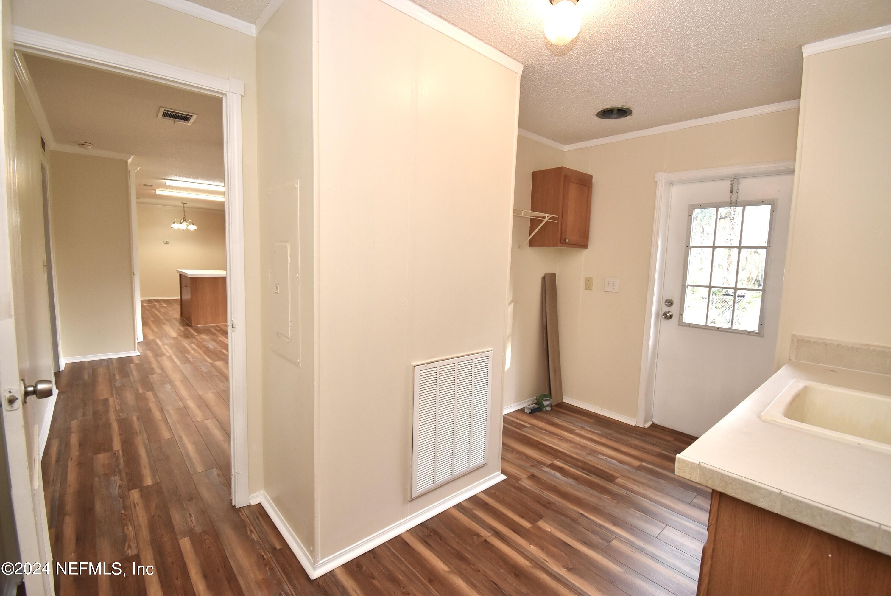 989 Shell Street Welaka, FL 32193 - Photo 24 of 34 a view of a hallway with wooden floor and cabinet