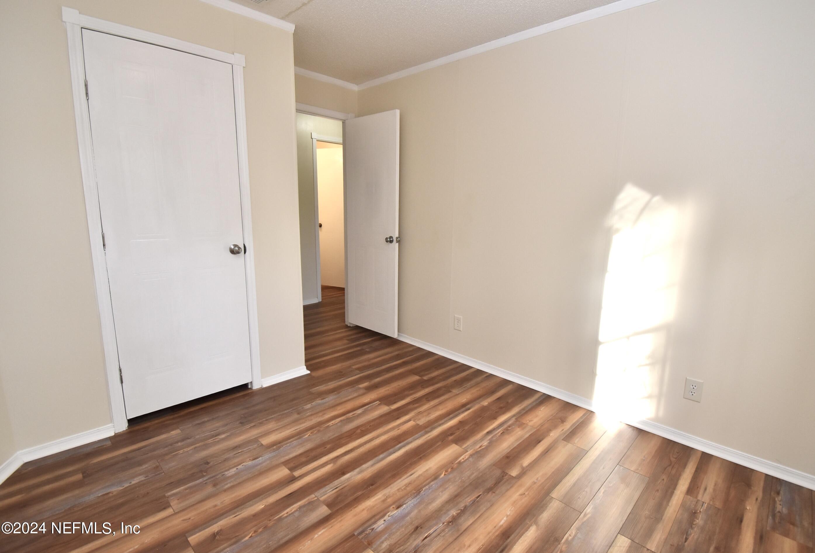989 Shell Street Welaka, FL 32193 - Photo 27 of 34 a view of an empty room with wooden floor