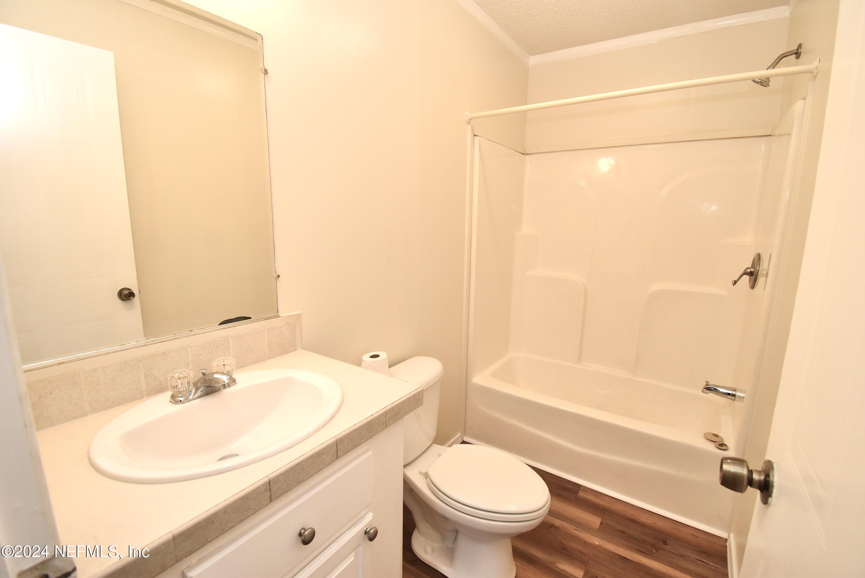 989 Shell Street Welaka, FL 32193 - Photo 28 of 34 a bathroom with a sink toilet and shower