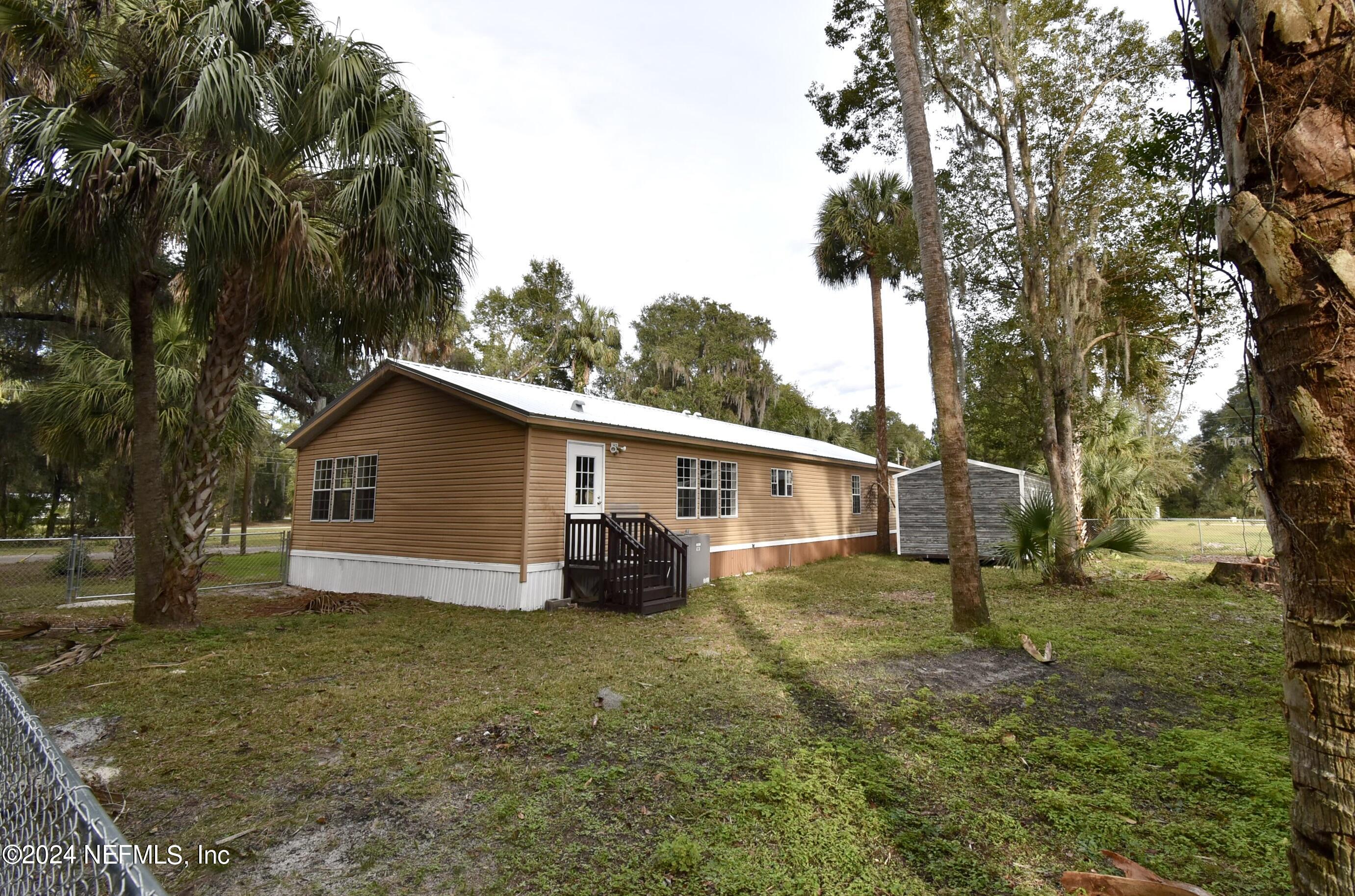 989 Shell Street Welaka, FL 32193 - Photo 3 of 34 a view of a house with a yard