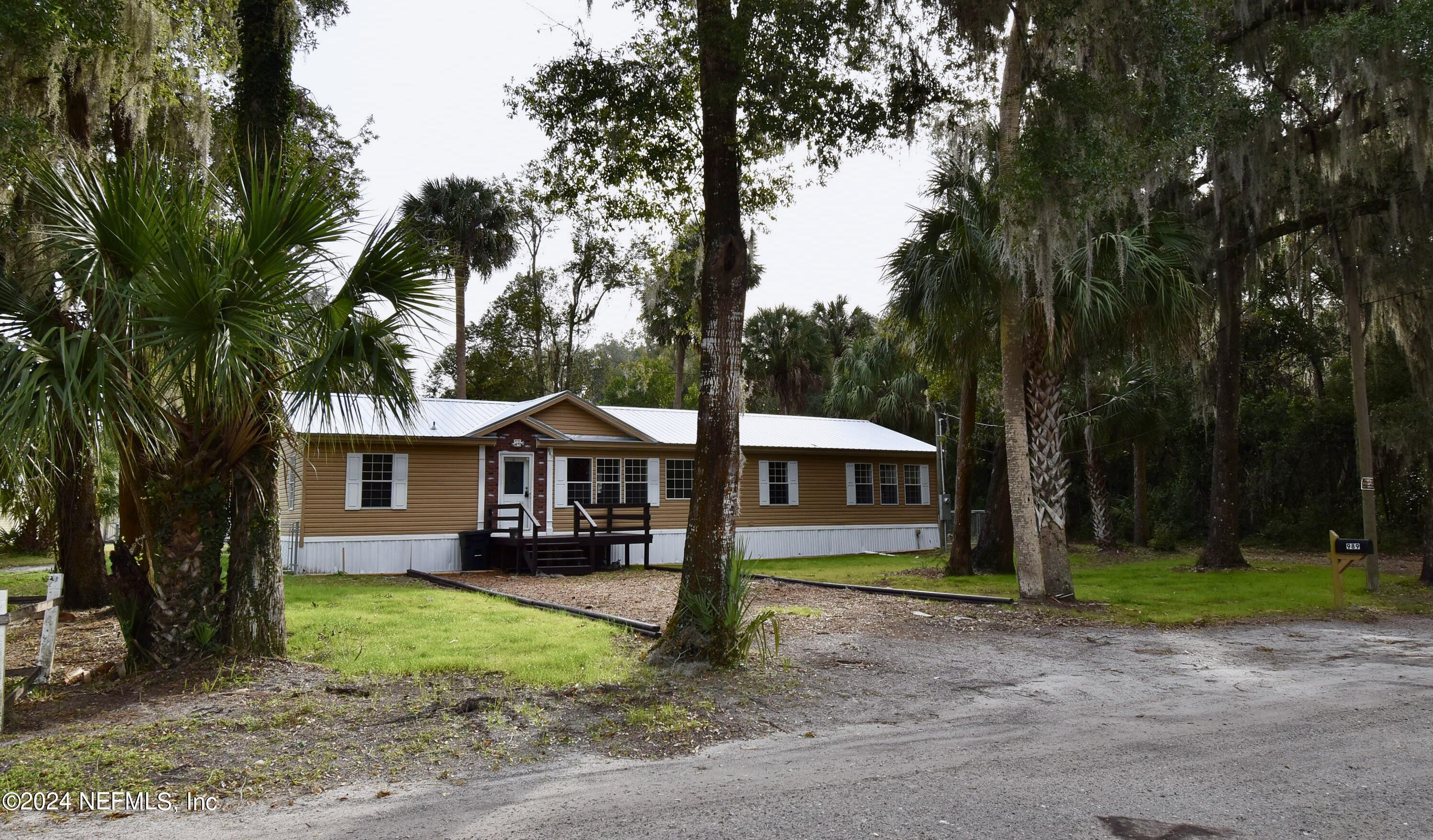 989 Shell Street Welaka, FL 32193 - Photo 34 of 34 a front view of a house with a yard and trees