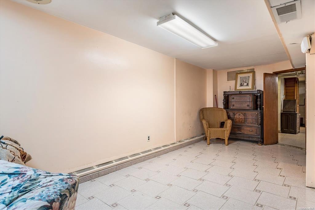1772 68th Street Brooklyn, NY 11204 - Photo 22 of 34 Living area with light flooring and baseboard heating
