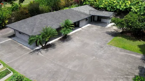 an aerial view of a house with a yard and potted plants