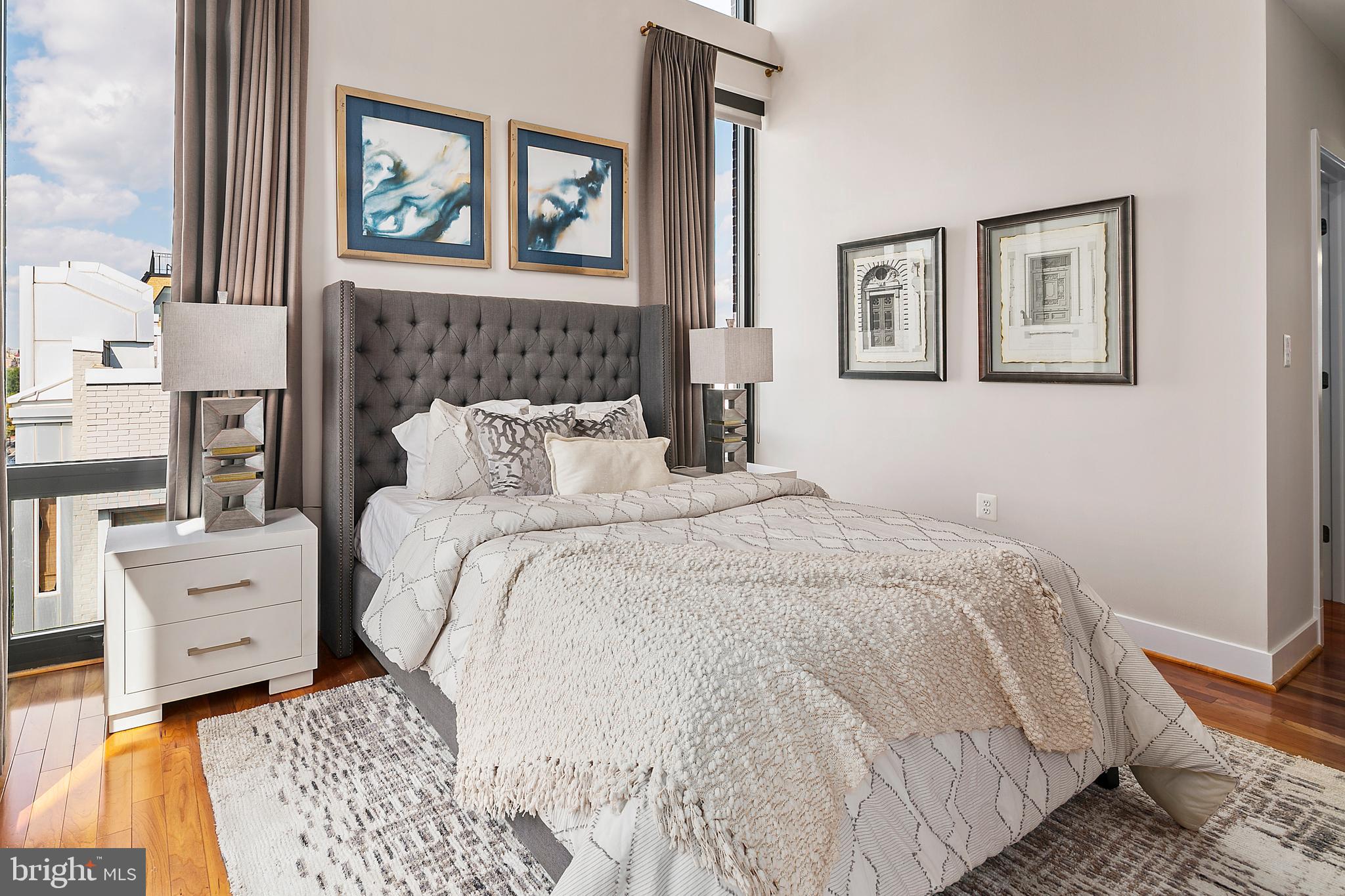 1211 13th Street Northwest, Unit 803 Washington, DC 20005 - Photo 12 of 29 a bedroom with a bed and a painting on the wall