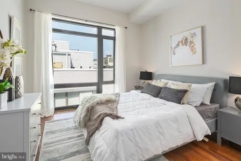a bedroom with bed and a window