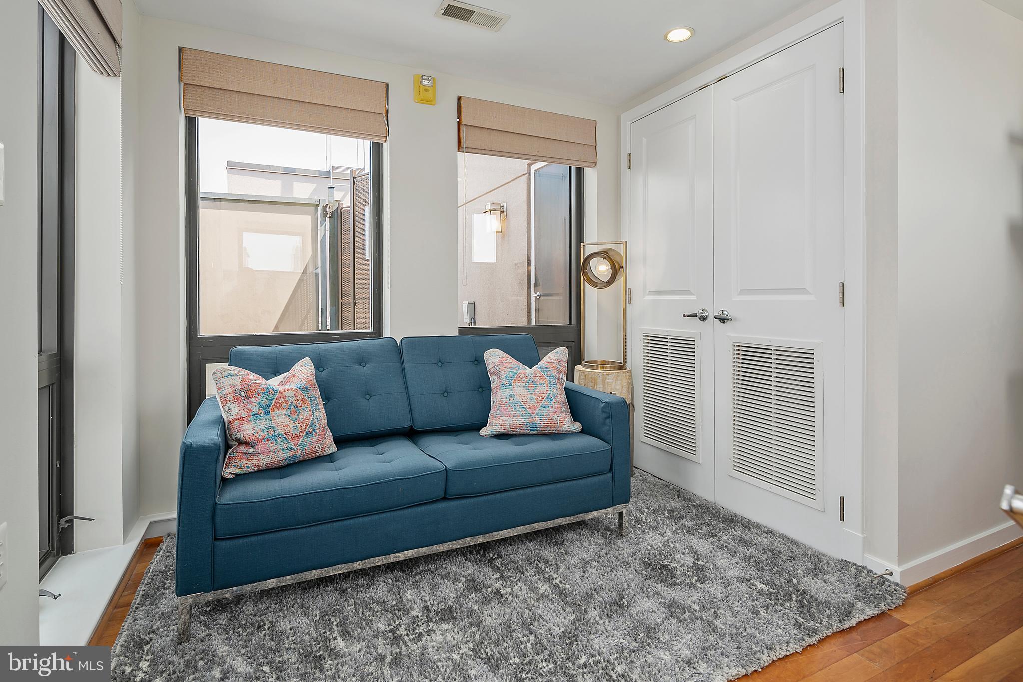 1211 13th Street Northwest, Unit 803 Washington, DC 20005 - Photo 21 of 29 a living room with furniture and a rug