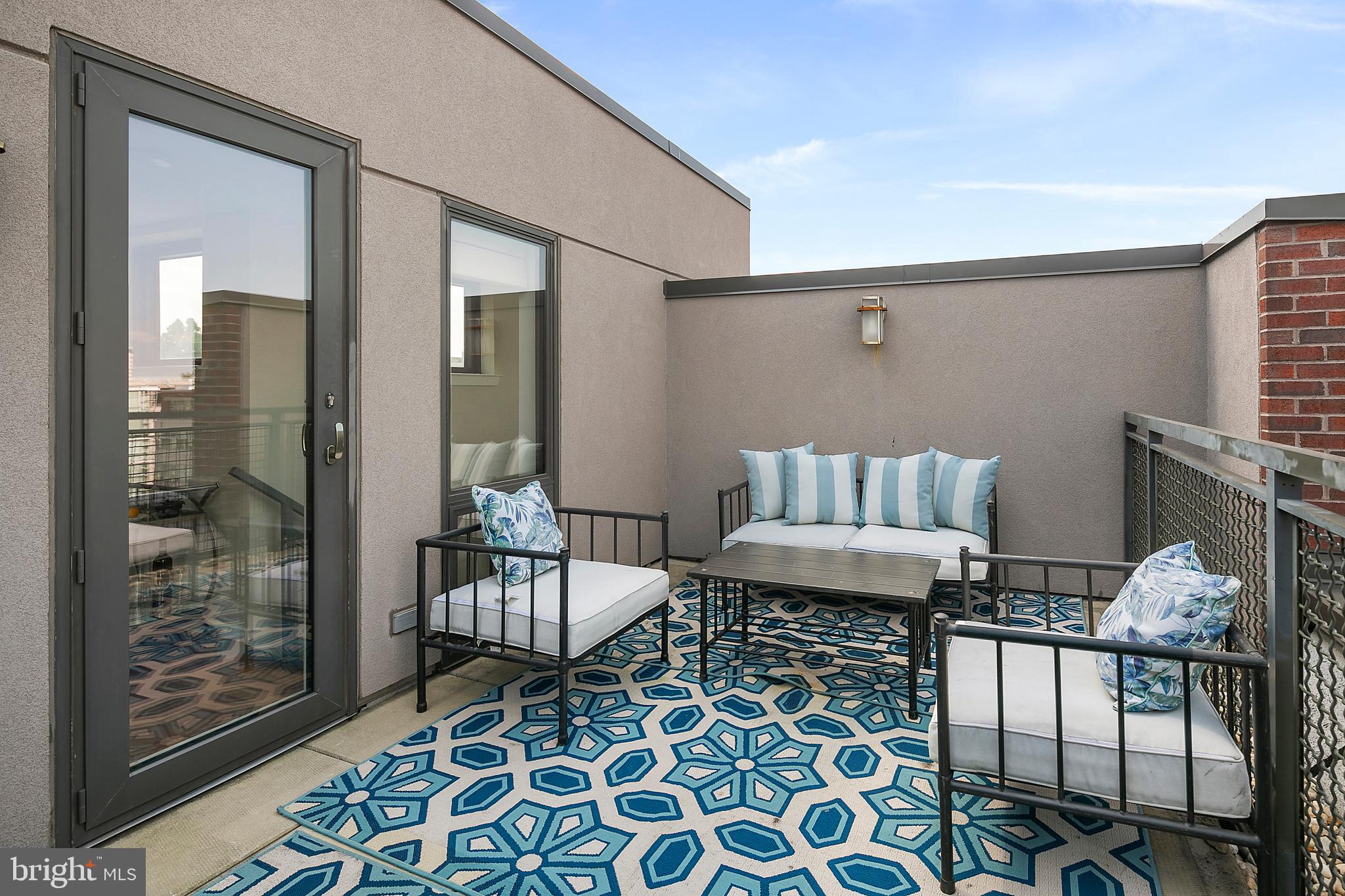 1211 13th Street Northwest, Unit 803 Washington, DC 20005 - Photo 24 of 29 a living room with furniture and a rug