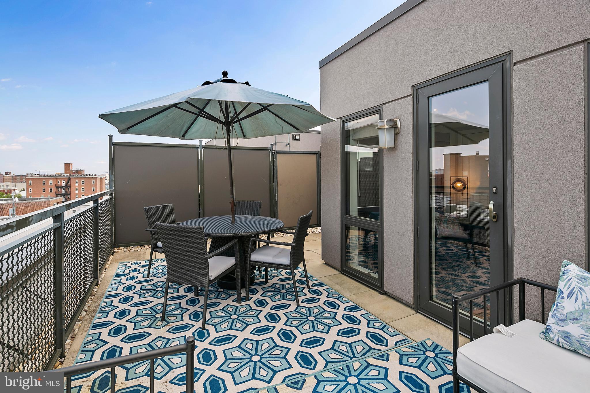 1211 13th Street Northwest, Unit 803 Washington, DC 20005 - Photo 25 of 29 a table and chairs in a balcony