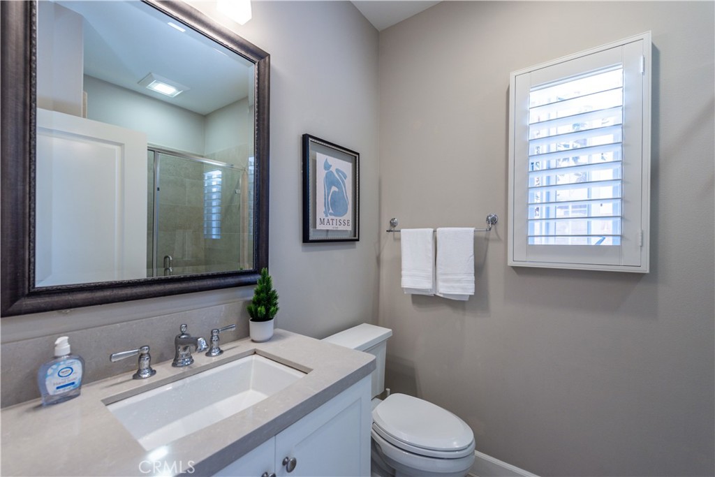 60 Trotter Irvine, CA 92602 - Photo 11 of 24 a bathroom with a granite countertop toilet sink and mirror