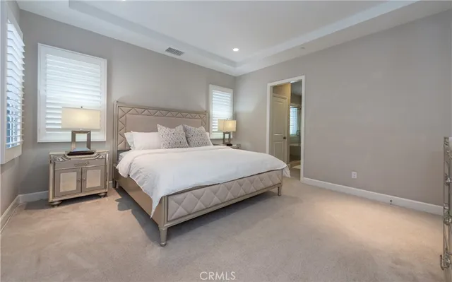 a bathroom with a granite countertop bathtub a double vanity sink and mirror