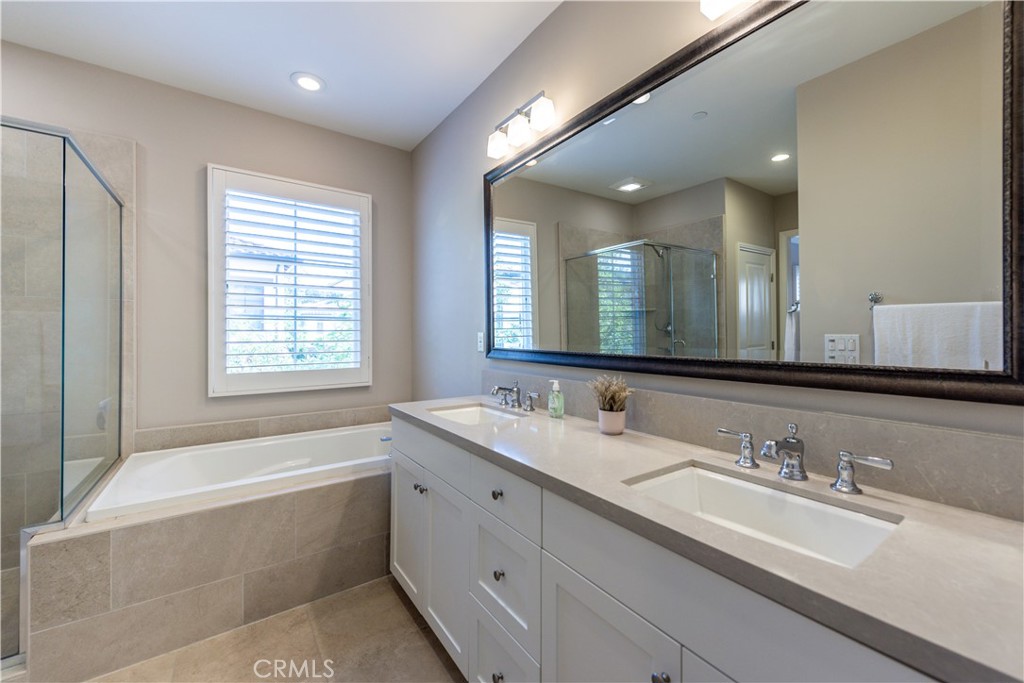 60 Trotter Irvine, CA 92602 - Photo 15 of 24 a bathroom with a granite countertop bathtub a double vanity sink and mirror