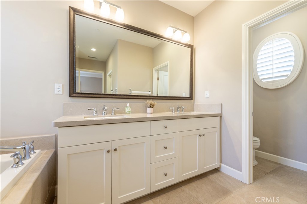 60 Trotter Irvine, CA 92602 - Photo 17 of 24 a bathroom with a sink and a mirror