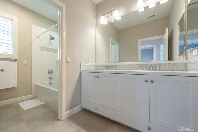 a white bath tub sitting next to a white sink
