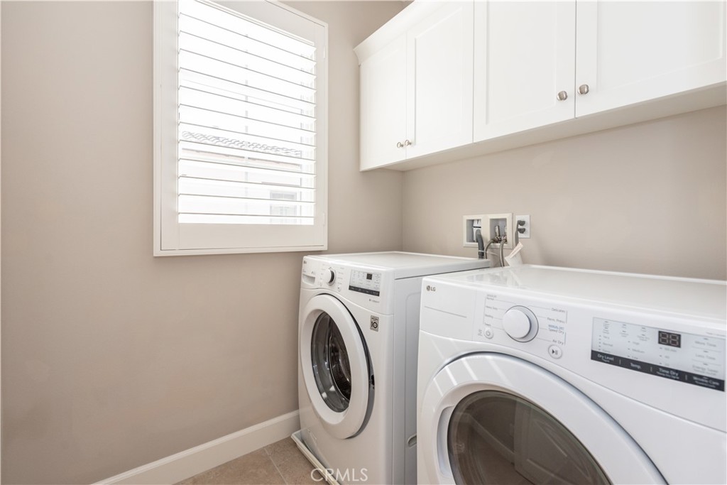60 Trotter Irvine, CA 92602 - Photo 24 of 24 a view of washer and dryer with kitchen in the background