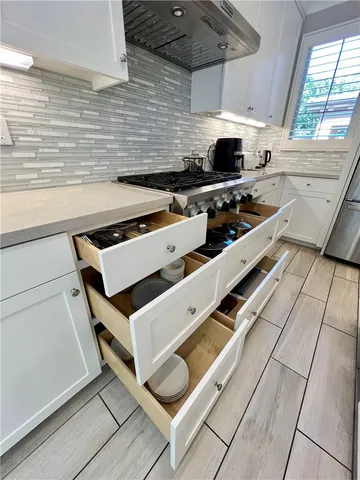 a living room with furniture and large windows