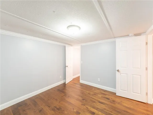 a bathroom with a bathtub shower sink vanity mirror and toilet