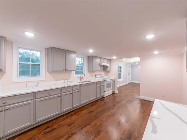 a kitchen with a sink cabinets and window