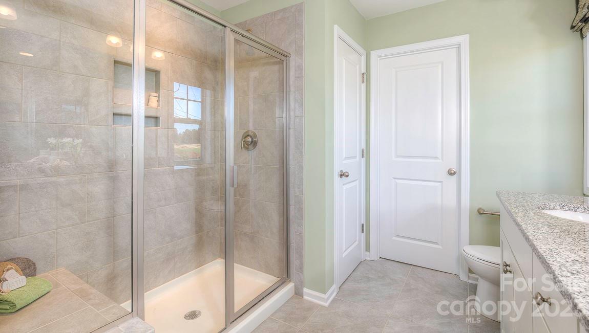 21 Ravens Rdg Road Hendersonville, NC 28792 - Photo 28 of 36 a bathroom with a shower and a toilet