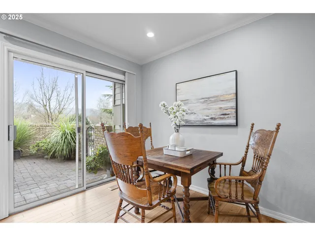 a dining room with furniture and wooden floor
