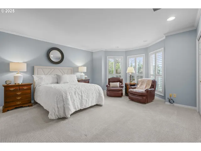 a bedroom with furniture and a large window