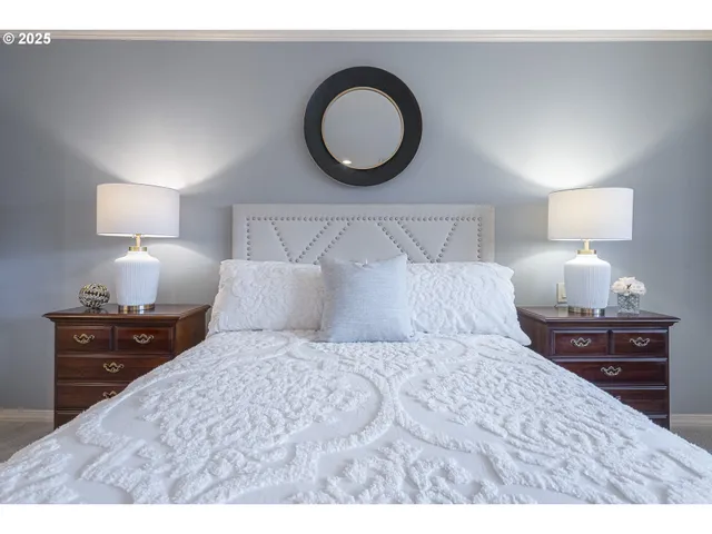 a bedroom with a bed and a lamp