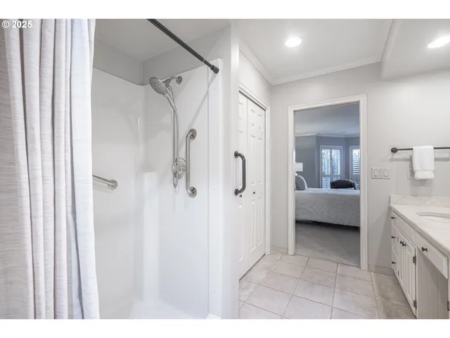 a en suite bathroom with a shower sink and a mirror