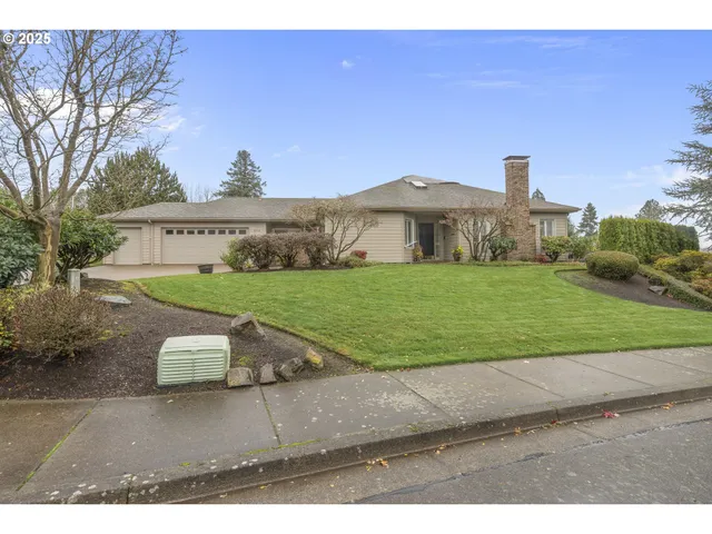 a view of a house with a yard and a garage