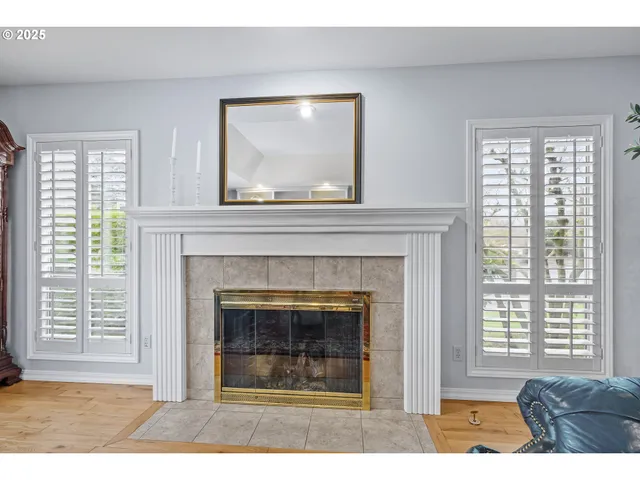 a living room with a fireplace and windows