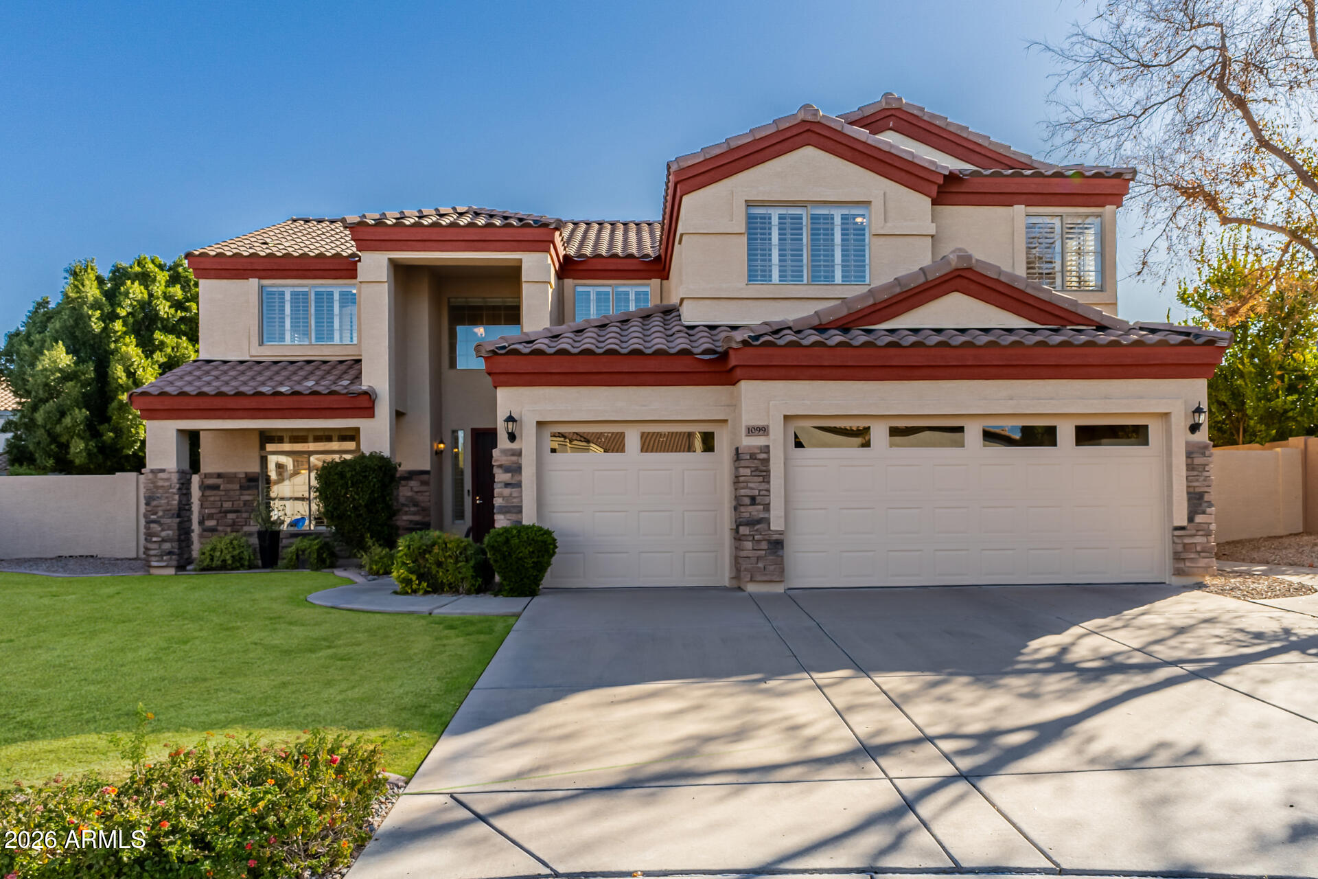 1099 South Justine Court Gilbert, AZ 85296 - Photo 1 of 60 a front view of a house with a garden and plants