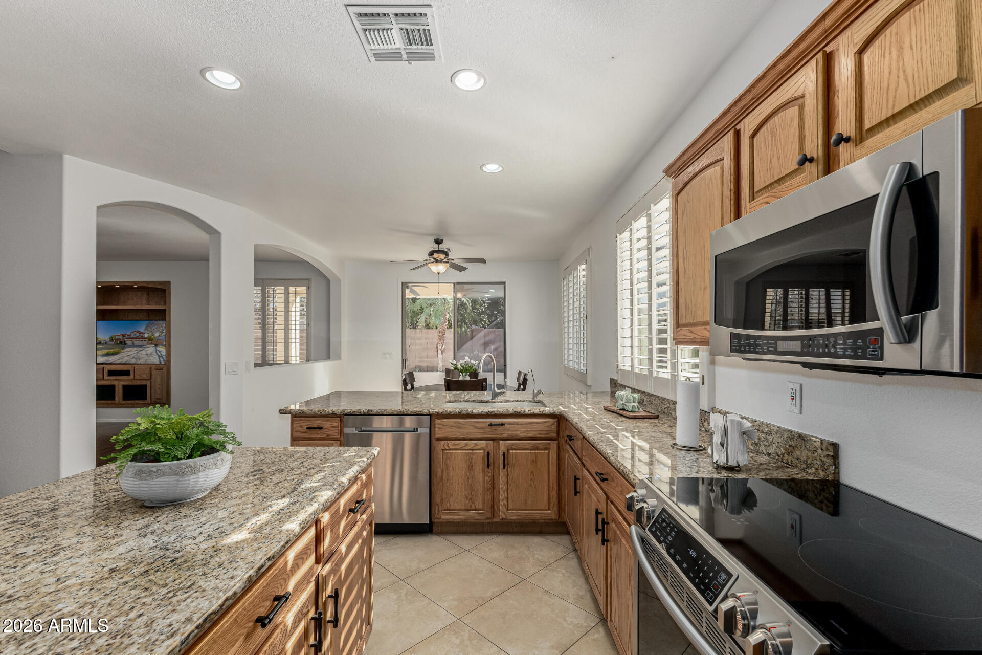 1099 South Justine Court Gilbert, AZ 85296 - Photo 9 of 60 a kitchen with lots of counter top space sink and stainless steel appliances
