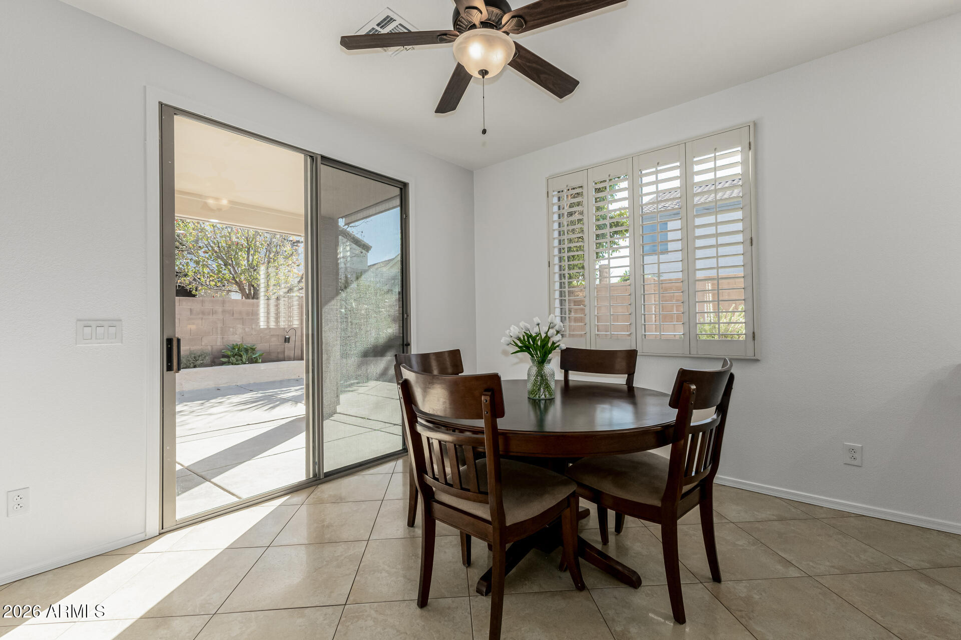 1099 South Justine Court Gilbert, AZ 85296 - Photo 10 of 60 a dining room with furniture a chandelier and wooden floor