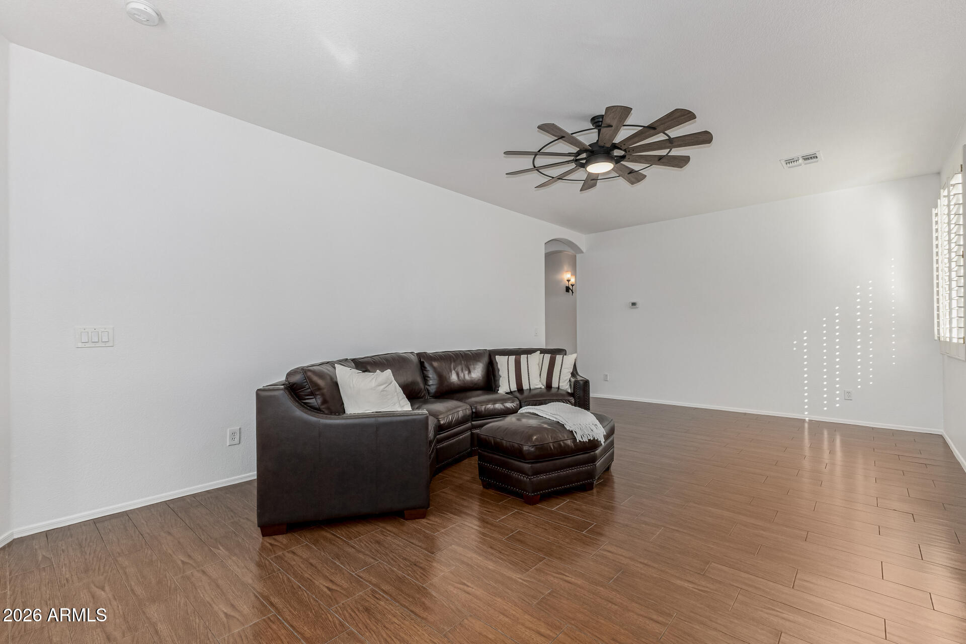 1099 South Justine Court Gilbert, AZ 85296 - Photo 16 of 60 a living room with furniture and a hard wood floor