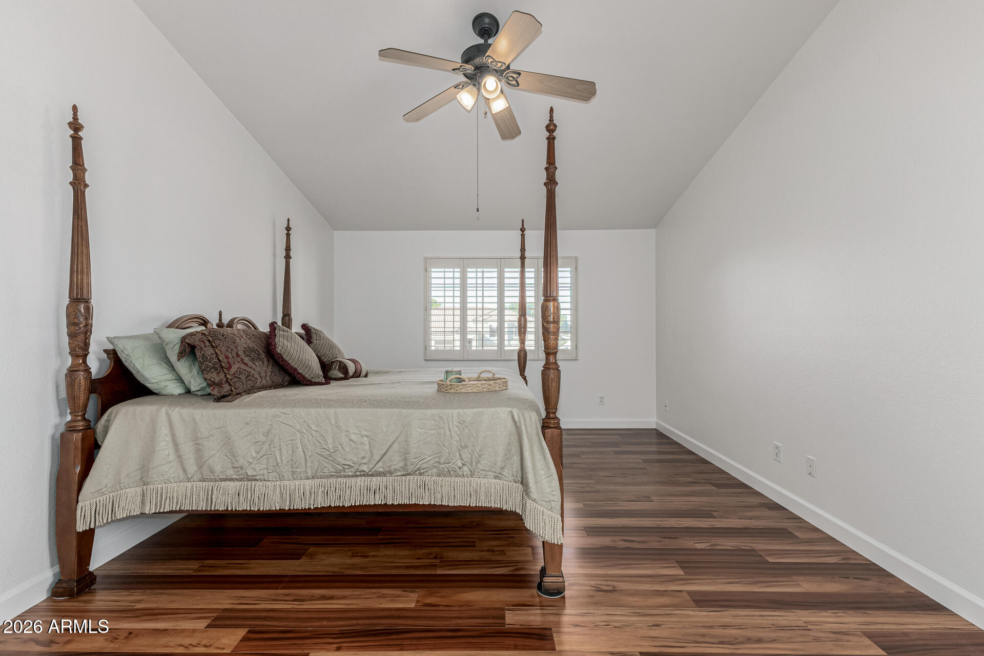1099 South Justine Court Gilbert, AZ 85296 - Photo 24 of 60 a bedroom with a bed and a chandelier