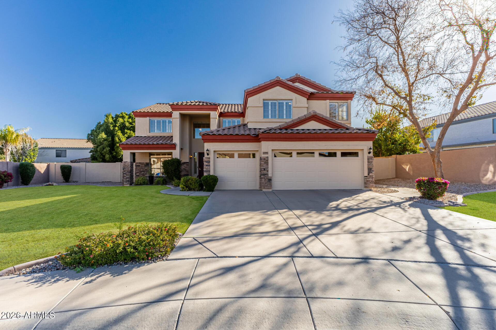 1099 South Justine Court Gilbert, AZ 85296 - Photo 2 of 60 a front view of a house with a garden