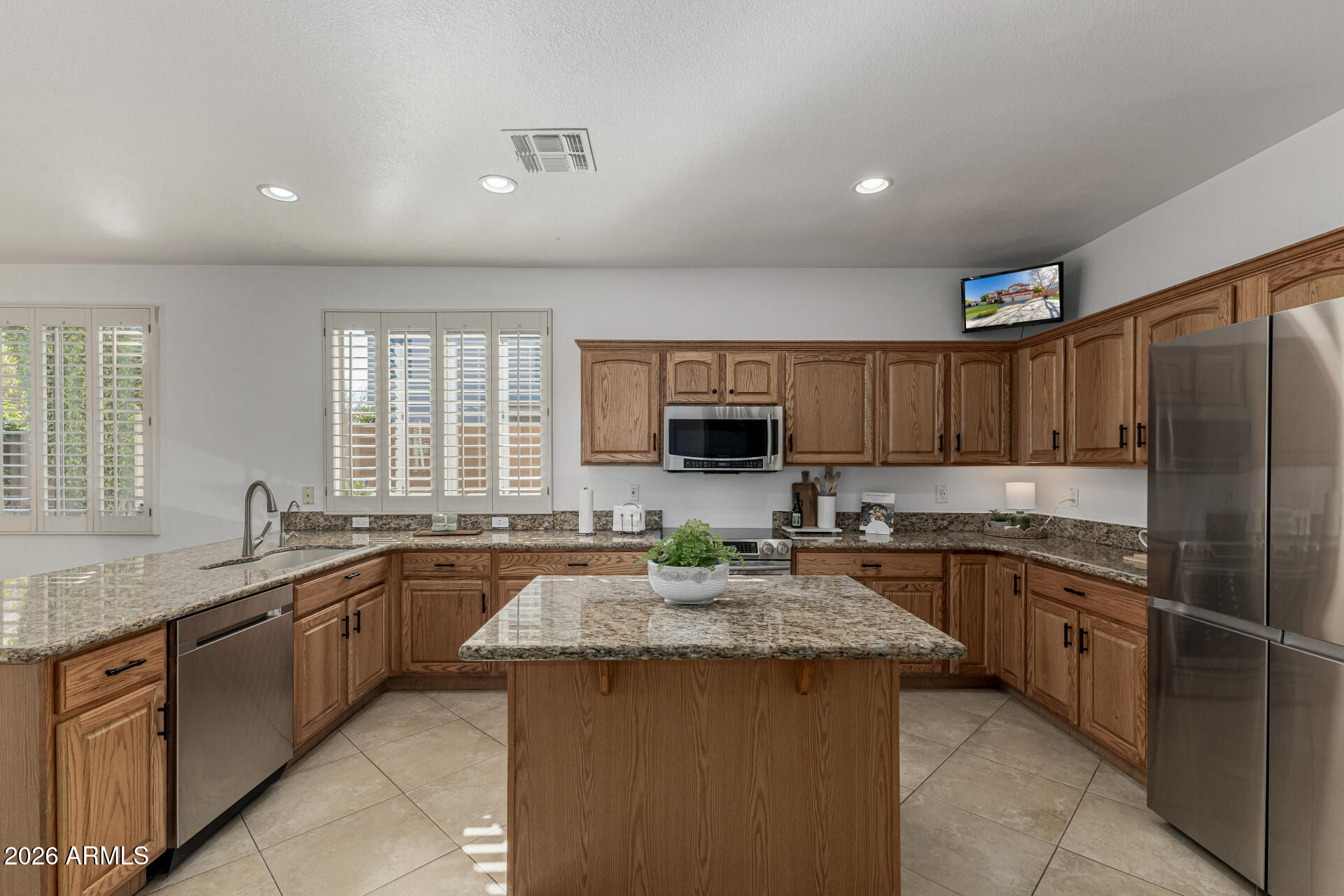1099 South Justine Court Gilbert, AZ 85296 - Photo 7 of 60 a kitchen with lots of counter top space sink and a window